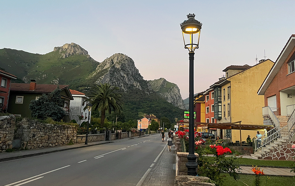 A street in Arenas de Cabrales framed by limestone peaks of the Picos de Europa National Park