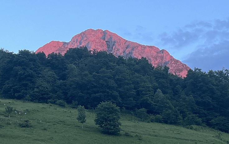 Picos mountains cast in pink glow at sunset