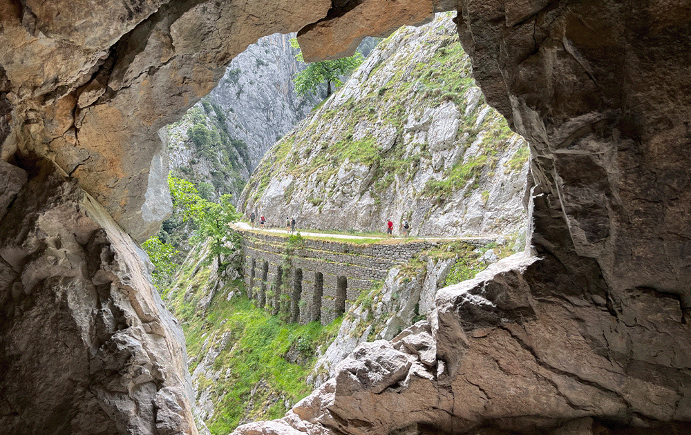 View of a gorge trail through a dramatic stone archway