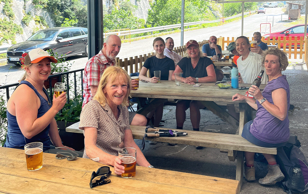 People enjoying post-hike beers at a cafe terrace