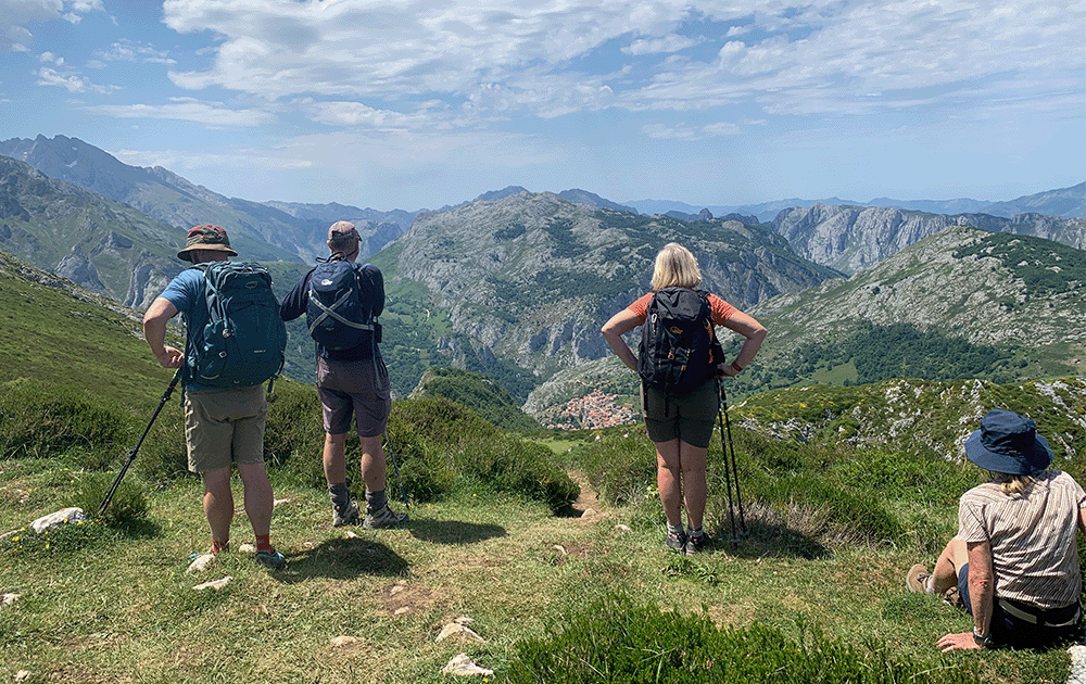 4 hikers looking over a mountain valley