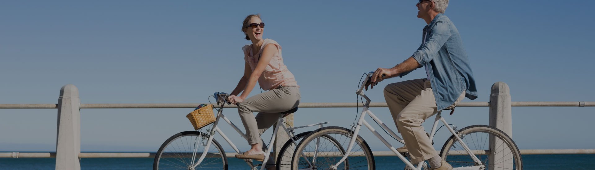 Couple riding bikes on a promenade