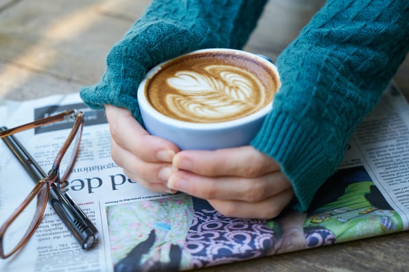 Coffee cup and newspaper