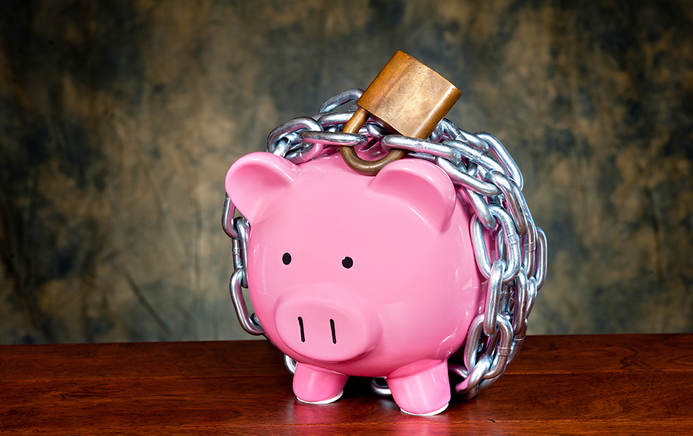 A piggy bank wrapped in a lock and chain