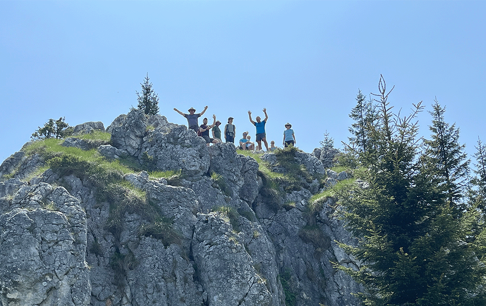 A group of people on top of a limestone outcrop