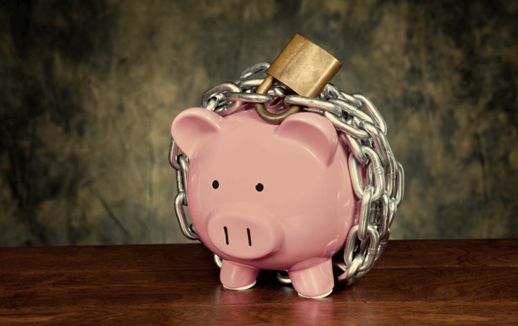 Piggy bank wrapped in a padlock and chain